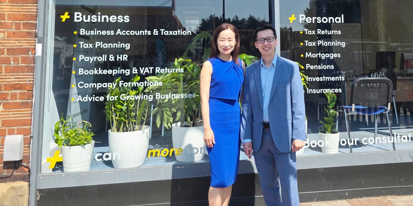 Accountants standing in front of a TaxAssist branch